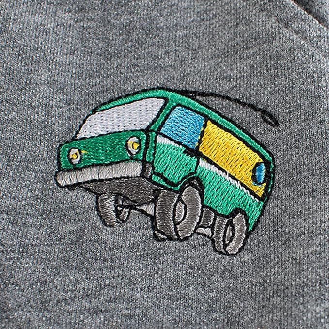 Close-up of a green vehicle embroidered on gray sweatpants