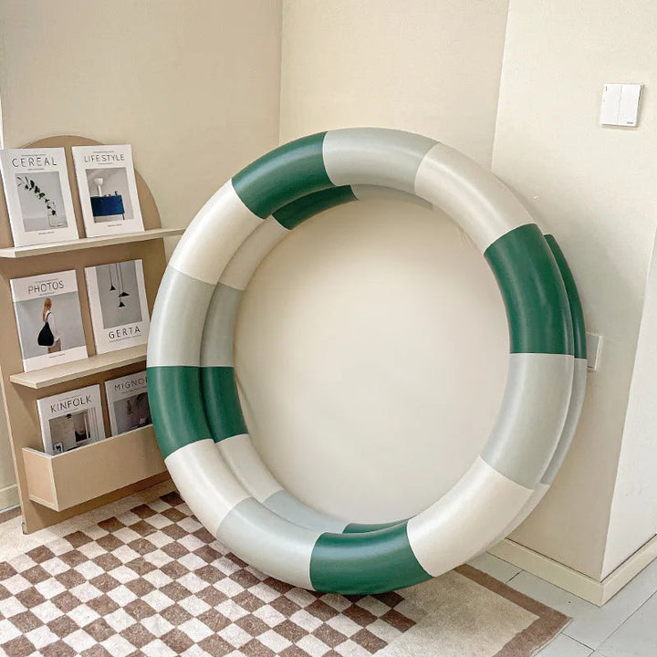 Green-and-white round inflatable pool with two stacked rings, displayed upright.
