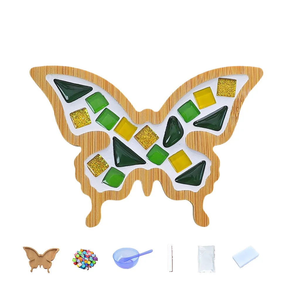Green and yellow butterfly mosaic coaster shown with bamboo base and crafting supplies