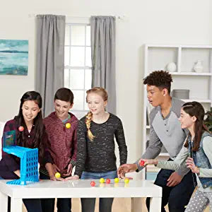 Group playing a blue four-in-a-row ball toss game around a table