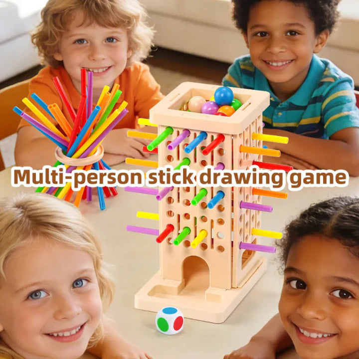 Four children gathered around a stick-pulling tower with colorful sticks and balls