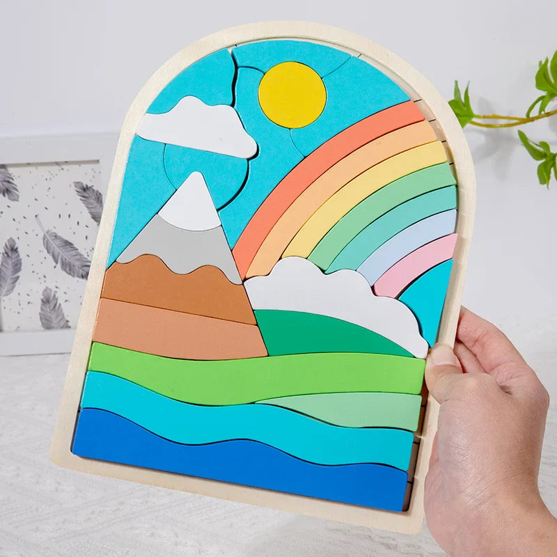 A hand holds an arched wooden puzzle with a rainbow, mountain, sun, and waves