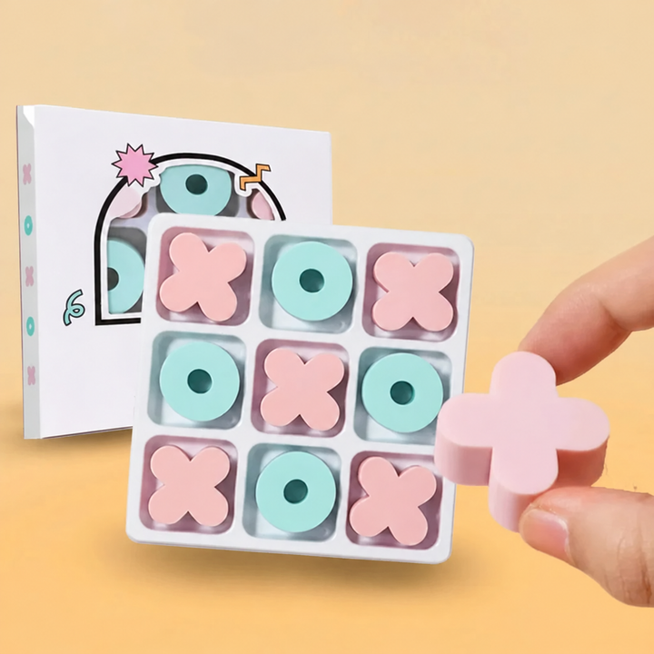 Hand holding a pink X eraser beside a filled tic-tac-toe board and its box.
