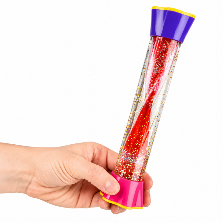 Hand holding a red and gold glitter sensory tube with pink and purple caps