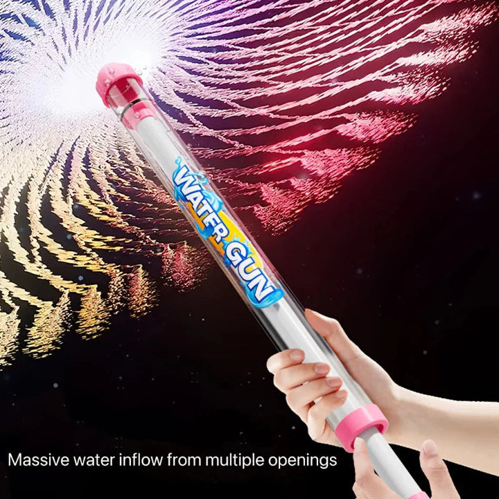Hands operating a pink pump water gun with a broad spray against a dark background.