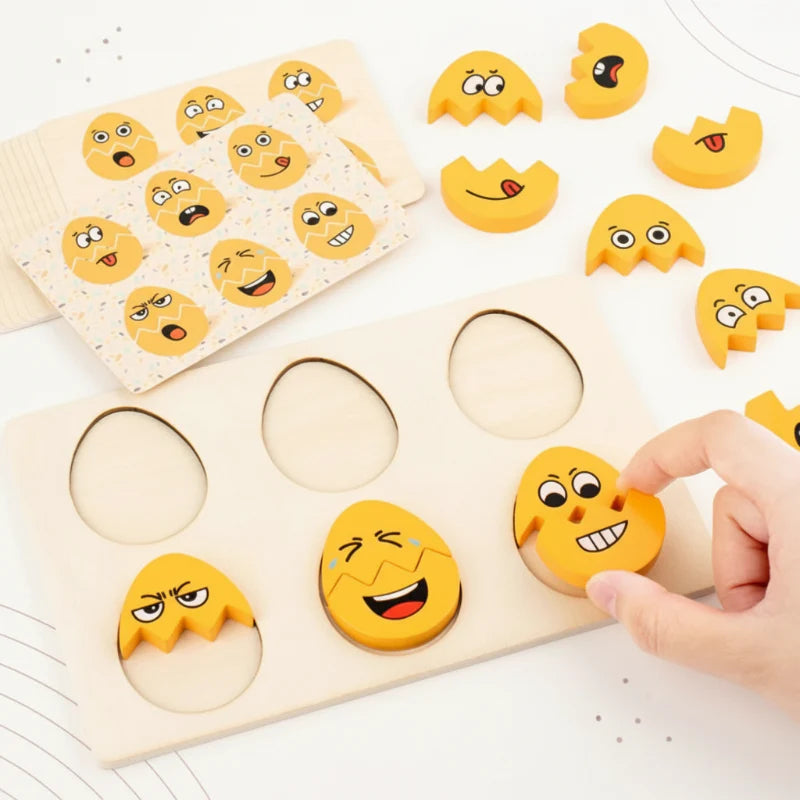 Hand fitting a yellow face piece into a wooden board with expression cards nearby