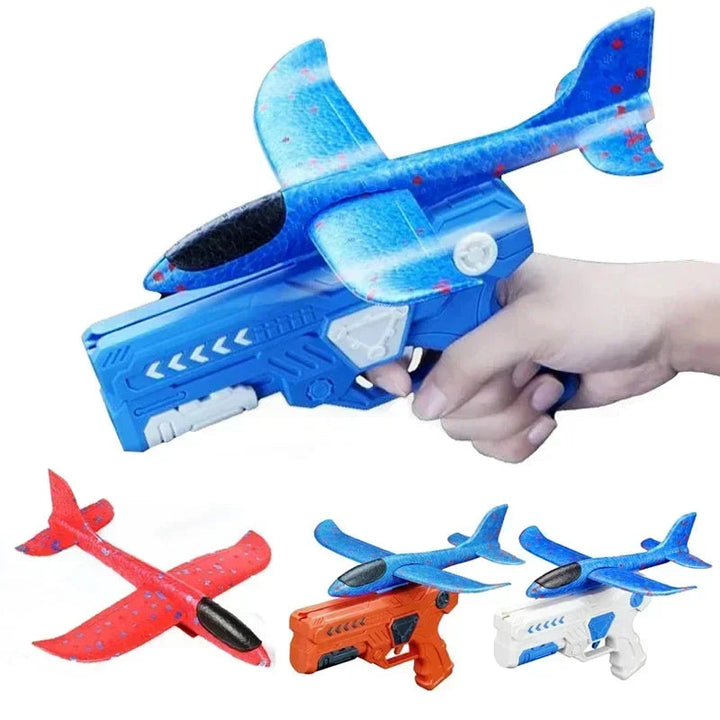 Hand holding a blue airplane launcher, with other launcher colors and foam airplanes shown below