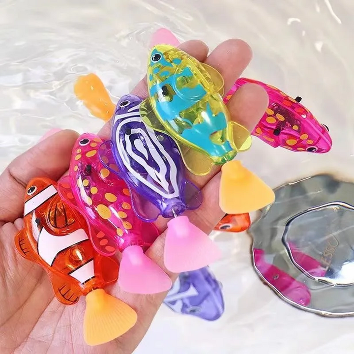 Hand holding colorful fish bath toys with flexible silicone tails
