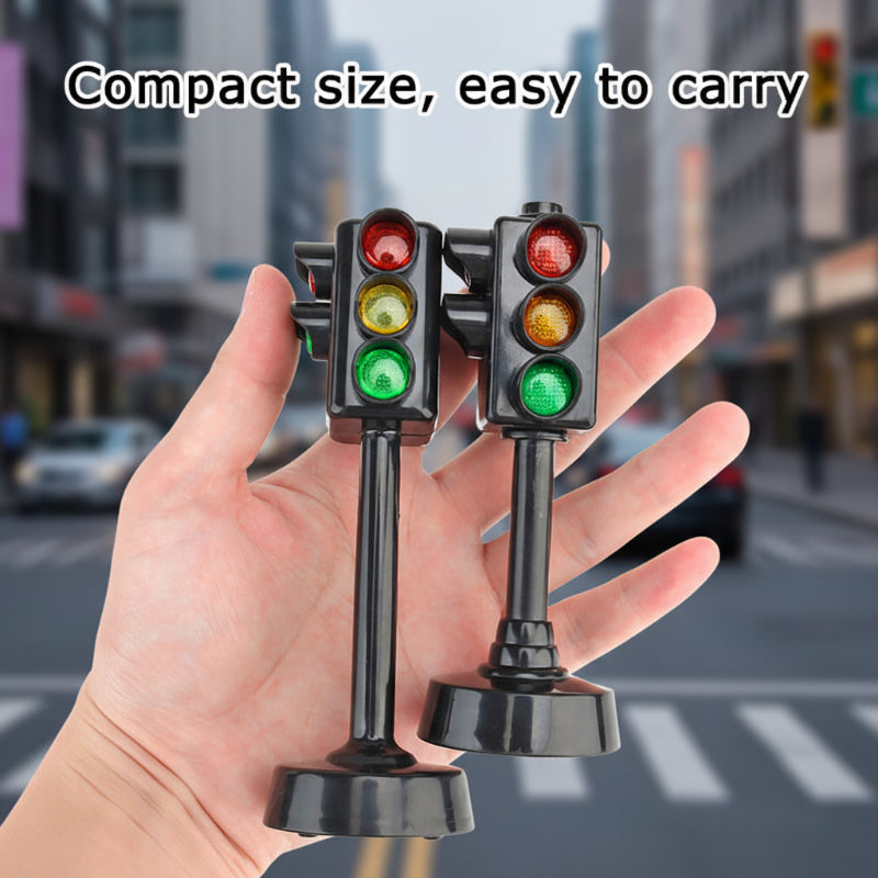 Two compact black traffic-light models resting in an open hand.