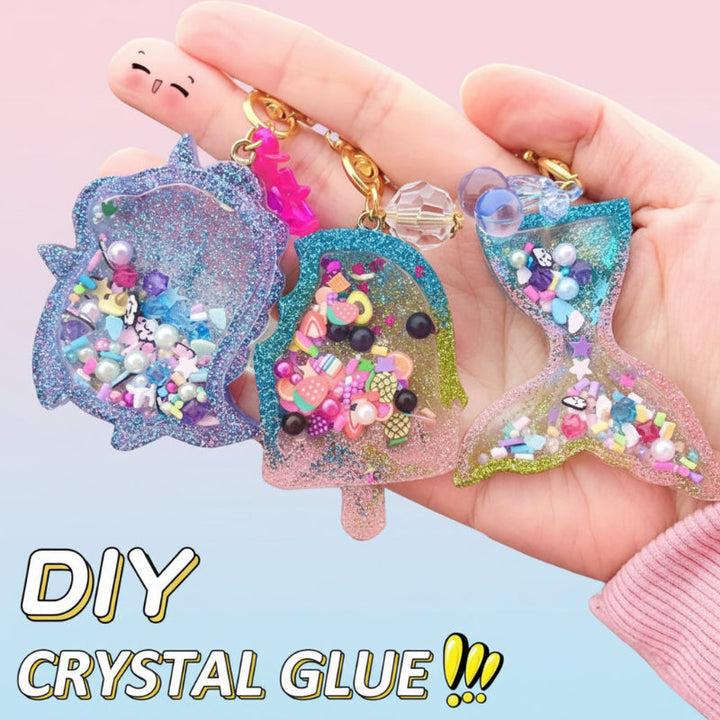 Hand holding three glitter-filled shaker keychains with beads and colorful decorative fillers