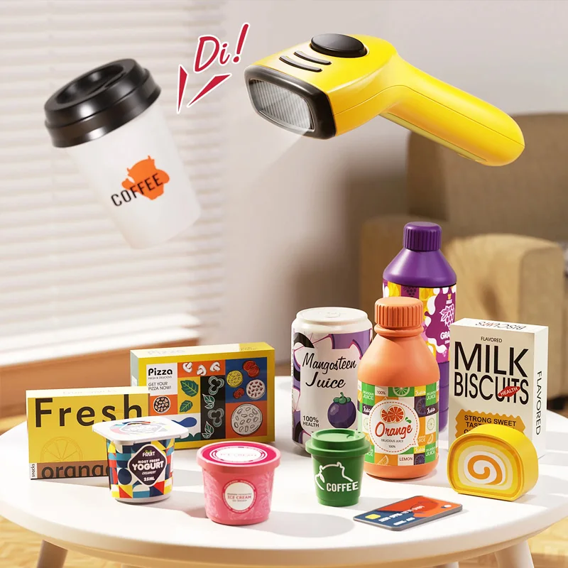 Handheld toy scanner above pretend drinks, boxed groceries and a payment card