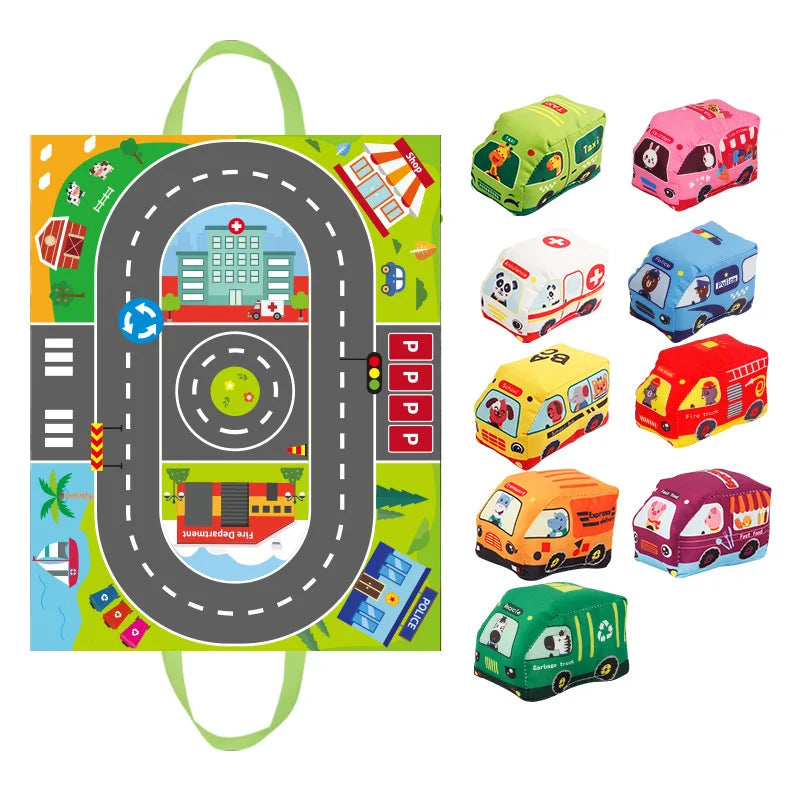 Road play mat with green carry handles beside an assortment of colorful soft toy vehicles