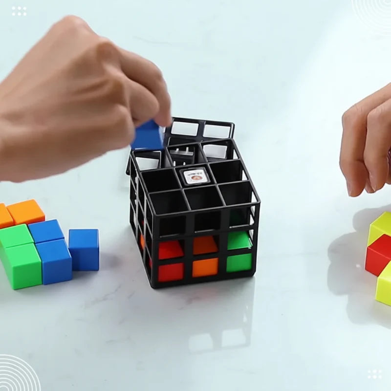 Hands placing a blue block into the open-frame puzzle cube on a table