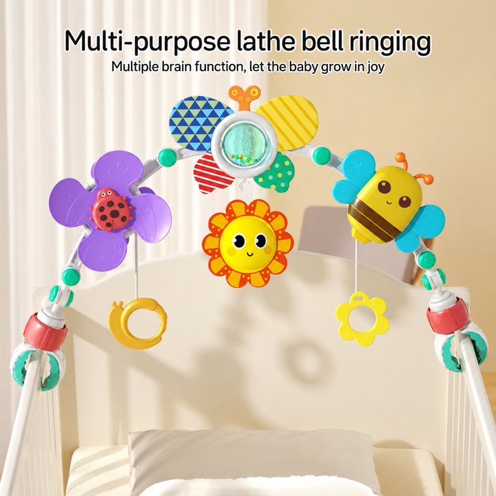 Colorful baby play arch with hanging rings positioned over a crib