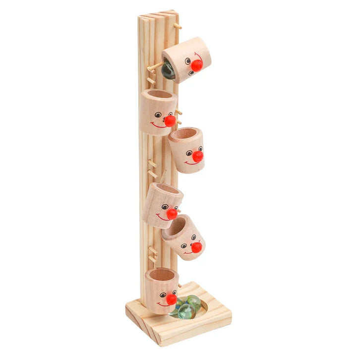 Wooden marble run with clown-face cups and a marble resting in the base
