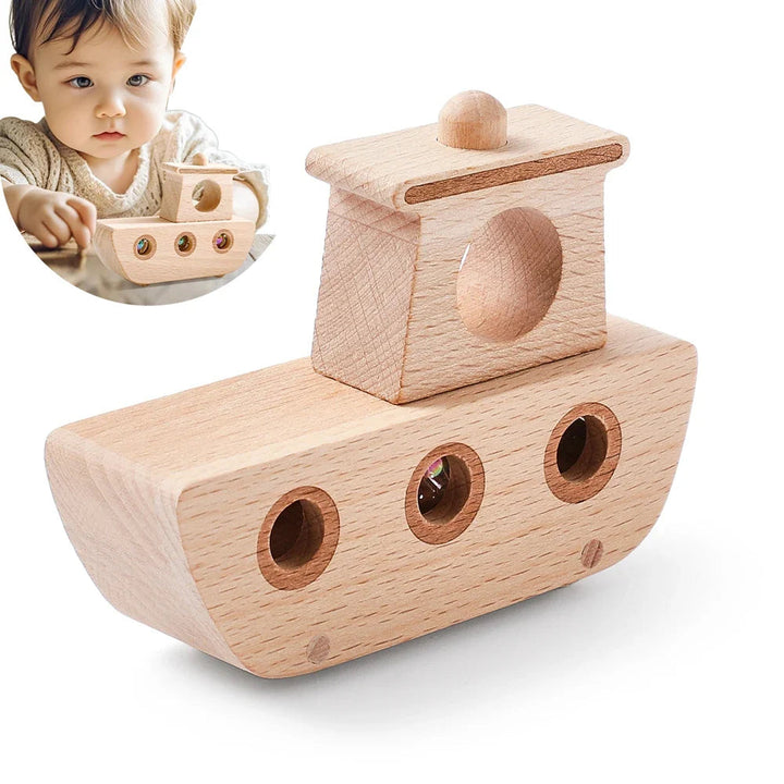 Wooden boat toy with three marble portholes, shown beside a child holding the boat.