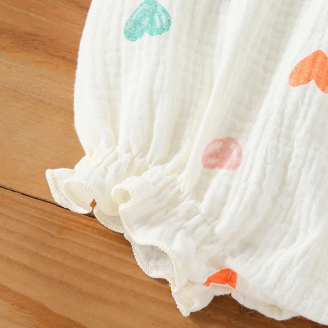 Gathered, ruffled leg opening on the multicolor heart-print bodysuit