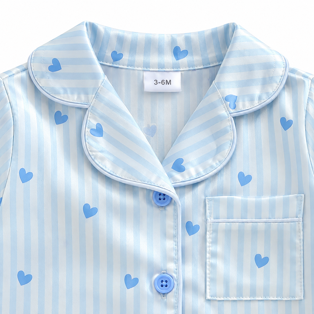 Close-up of the notched collar, blue buttons, and chest pocket on the striped heart-print jumpsuit