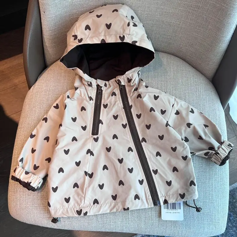 Heart-print hooded jacket showing its front zipper, elastic cuffs and adjustable hem.
