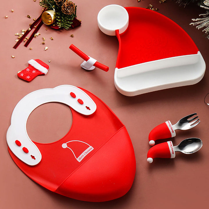 Red-and-white holiday mealtime set with a hat-shaped plate, bib, cutlery, and straw