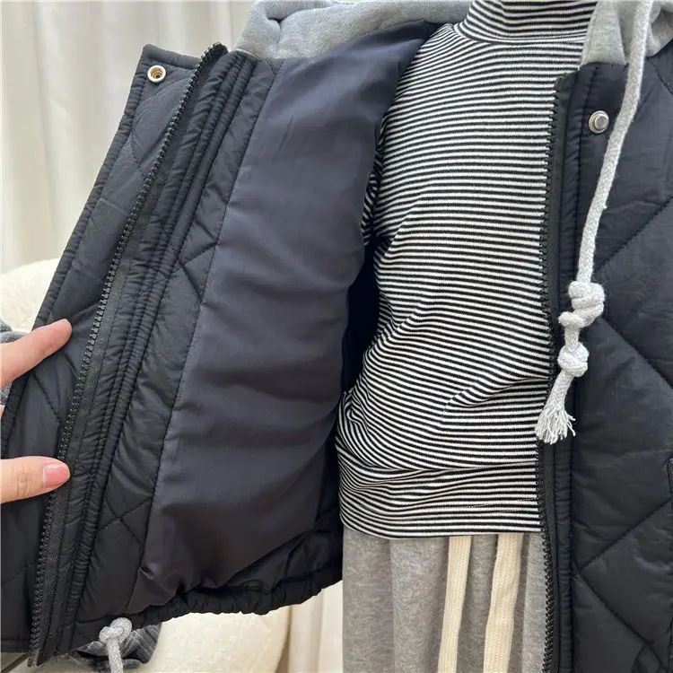 Open blue jacket showing the inner lining and front zipper beside a striped turtleneck.