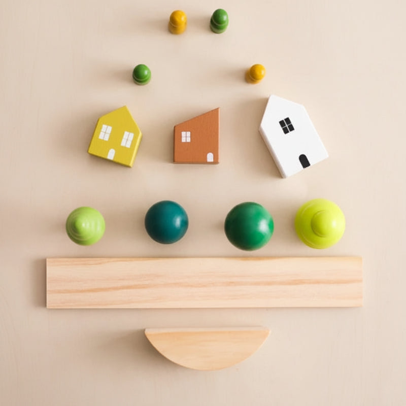 House pieces, tree shapes, figures, board, and curved base laid out separately