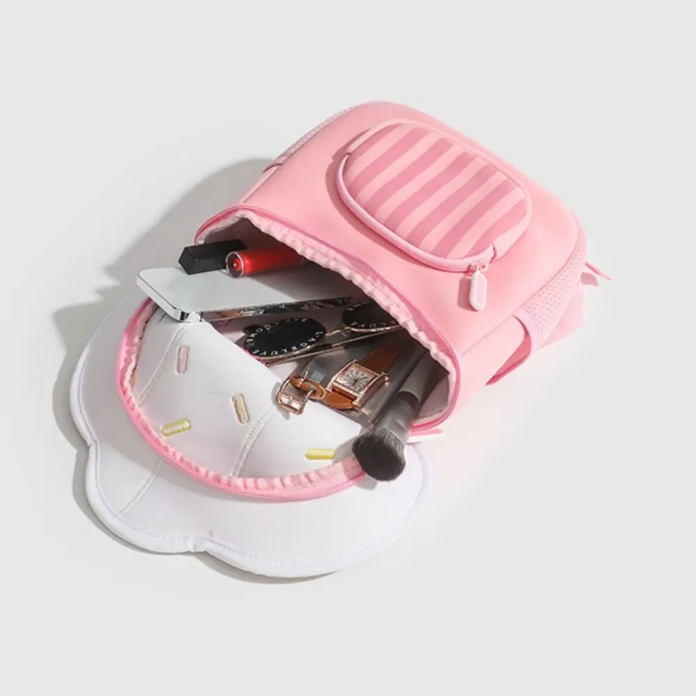 Ice Cream backpack with its main compartment open and small personal items inside.