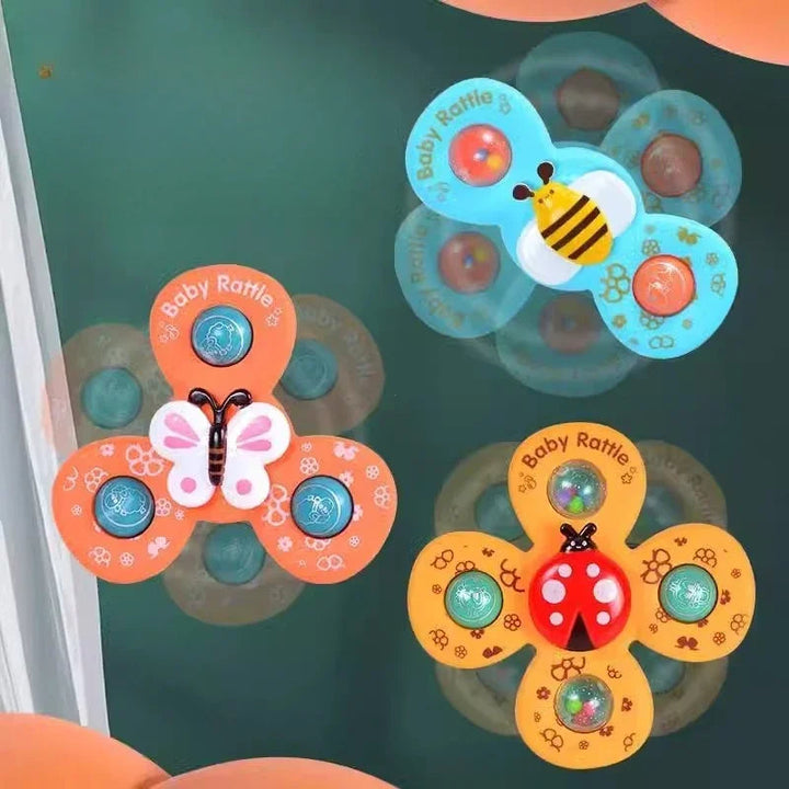 Bee, butterfly, and ladybug suction spinners shown rotating on glass