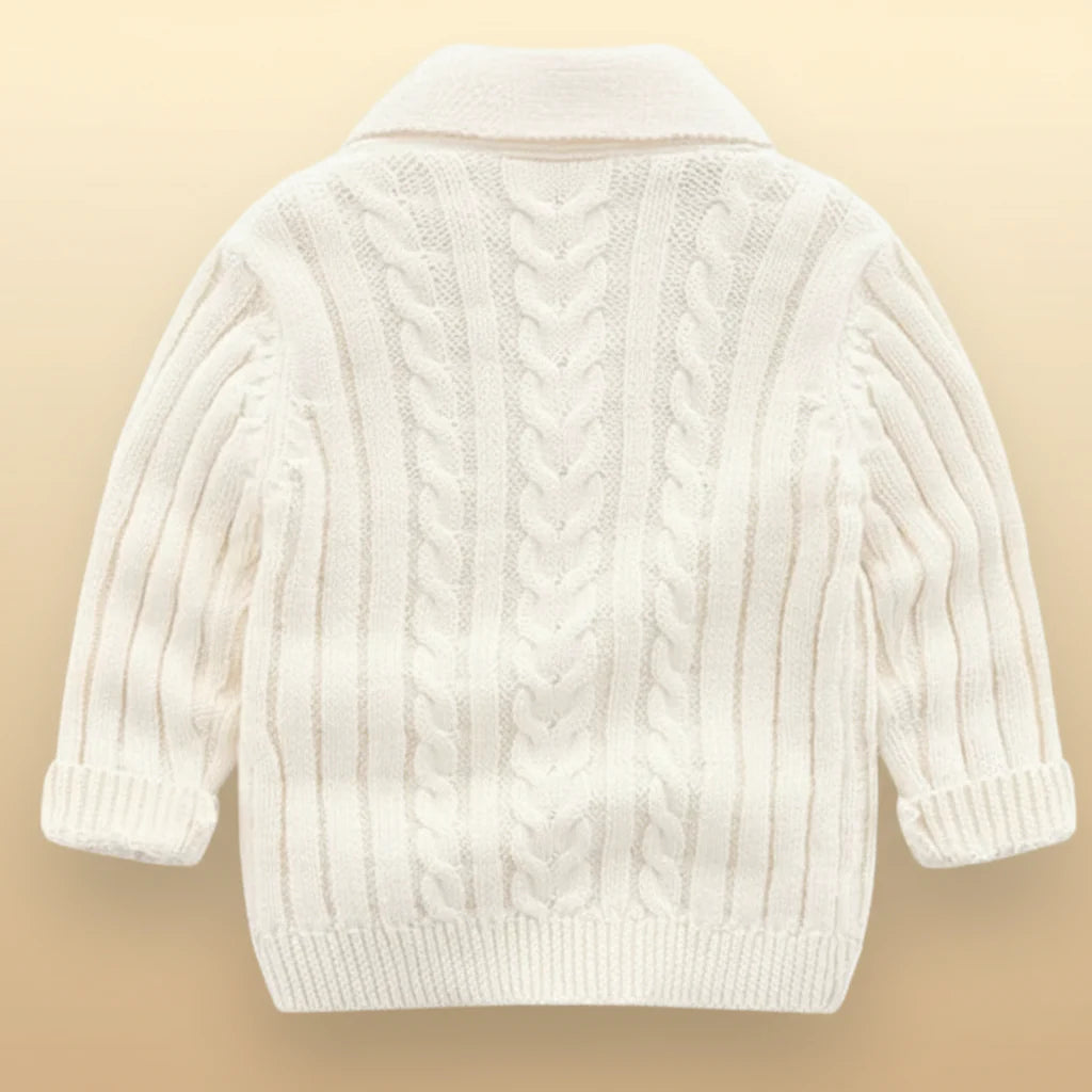 Back view of an ivory cable-knit baby cardigan with a fold-over collar and ribbed hem