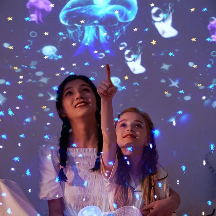 A woman and child watching colorful jellyfish and star projections above a dual-lens night light.