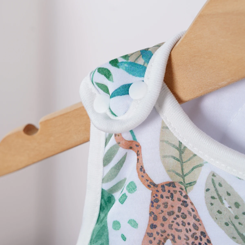 Close-up of a shoulder snap on a jungle-print baby sleep sack