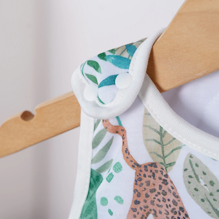 Close-up of a shoulder snap on a jungle-print baby sleep sack