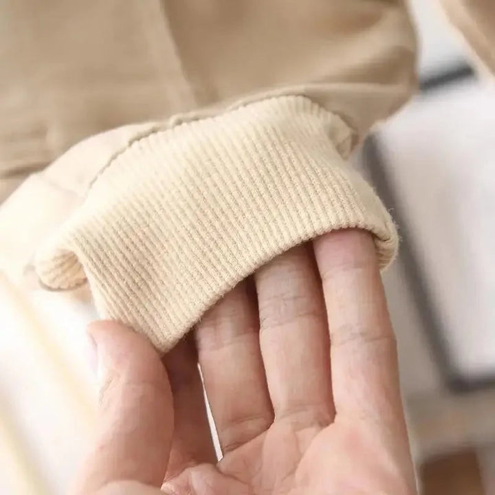 Close-up of the ribbed ankle cuff on khaki cotton cargo pants