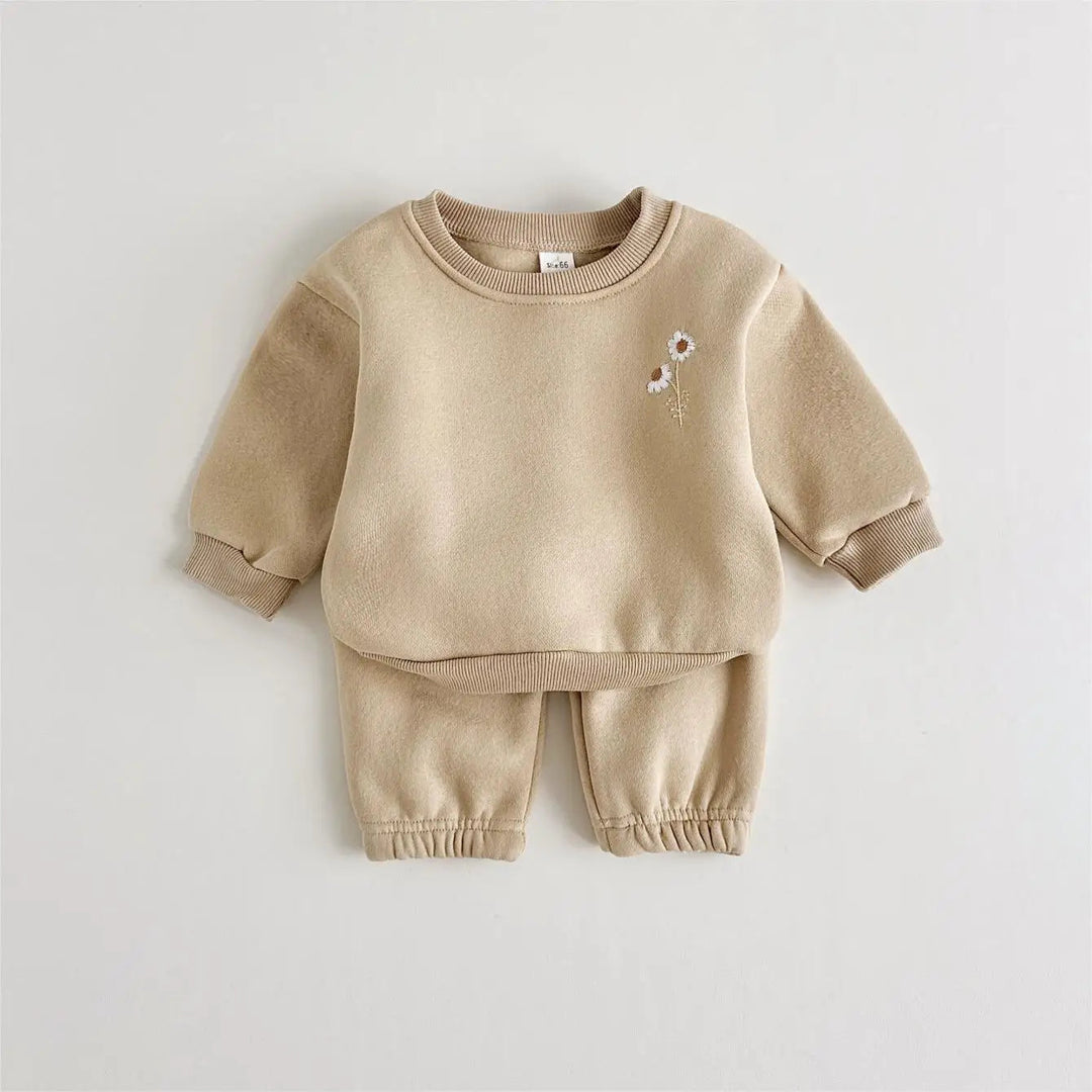 Khaki baby tracksuit showing the embroidered flowers, ribbed cuffs and matching pants