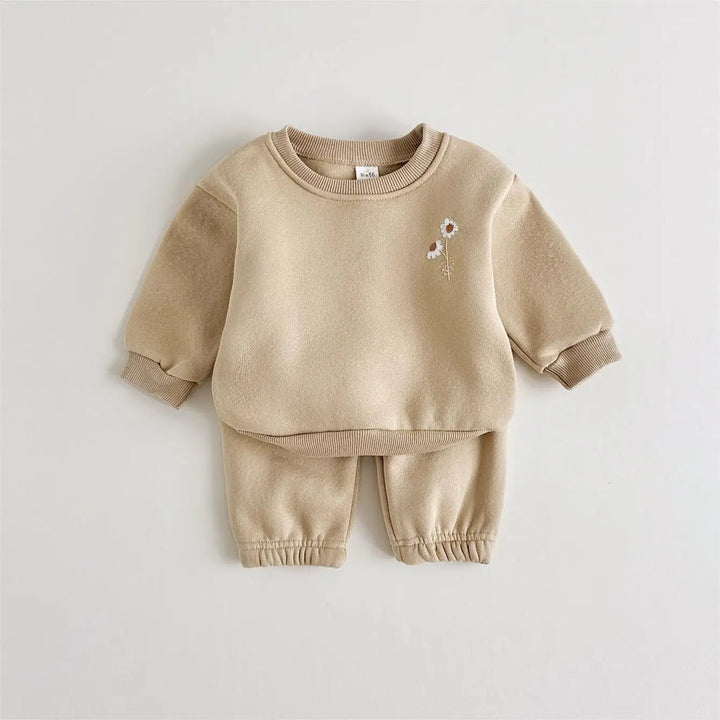 Khaki baby tracksuit showing the embroidered flowers, ribbed cuffs and matching pants