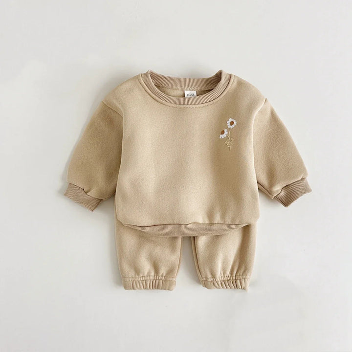 Front view of a khaki floral sweater and matching baby pants with gathered hems
