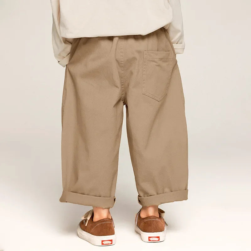 Back view of khaki pants showing patch pockets, a relaxed fit, and rolled cuffs.