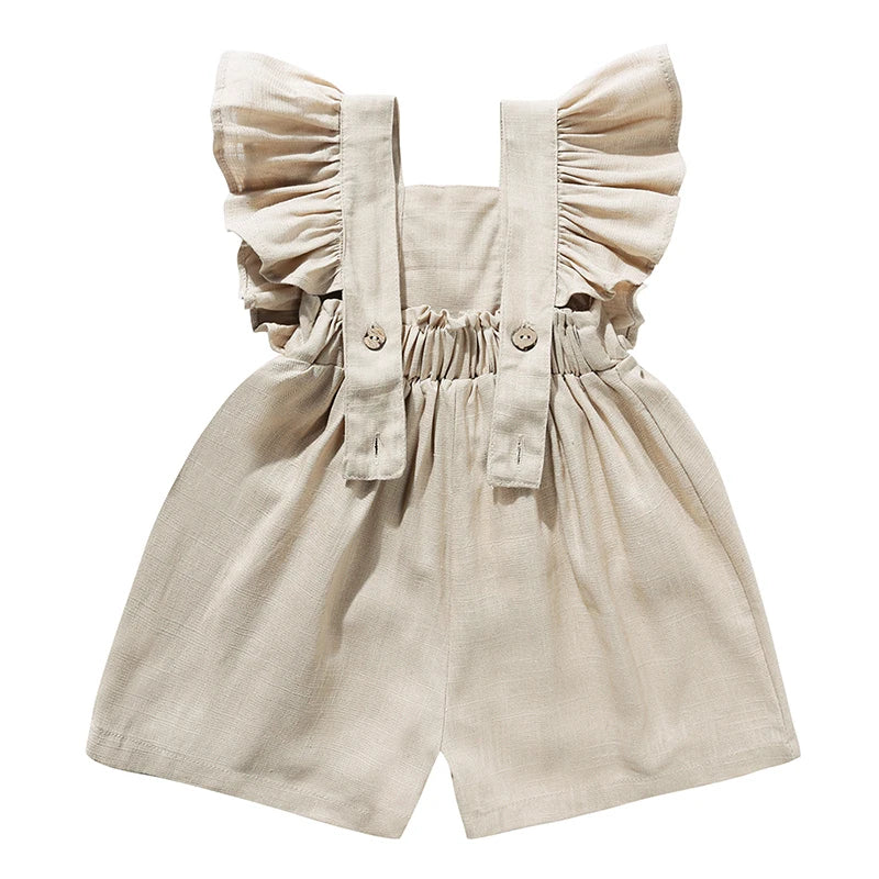 Back of the khaki romper showing ruffled straps, button fastenings, and a gathered waist.