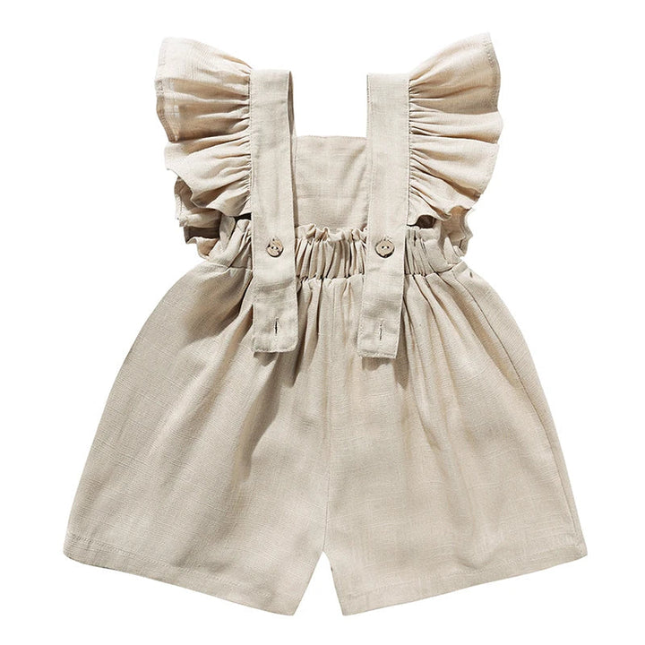 Back of the khaki romper showing ruffled straps, button fastenings, and a gathered waist.