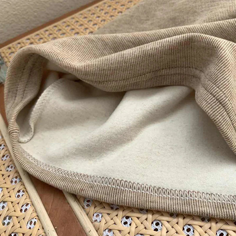 Inside of the khaki shirt showing the fleece interior and stitched hem