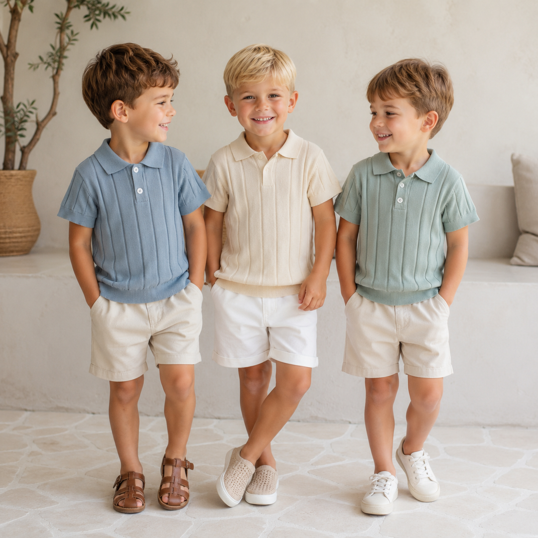 Three children wearing blue, cream, and green knit polo shirts with light-colored shorts