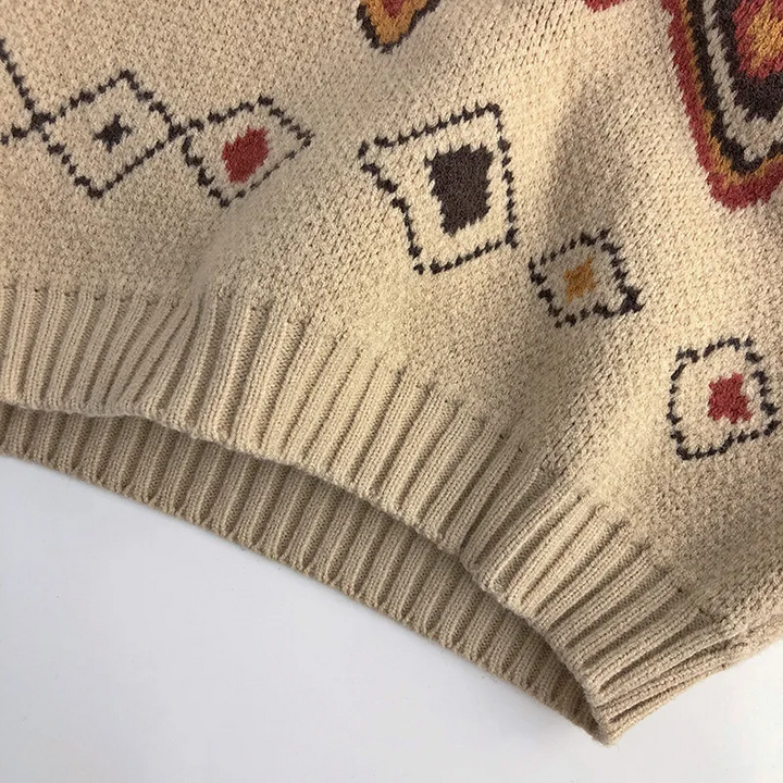 Ribbed hem and small geometric diamonds on the beige sweater