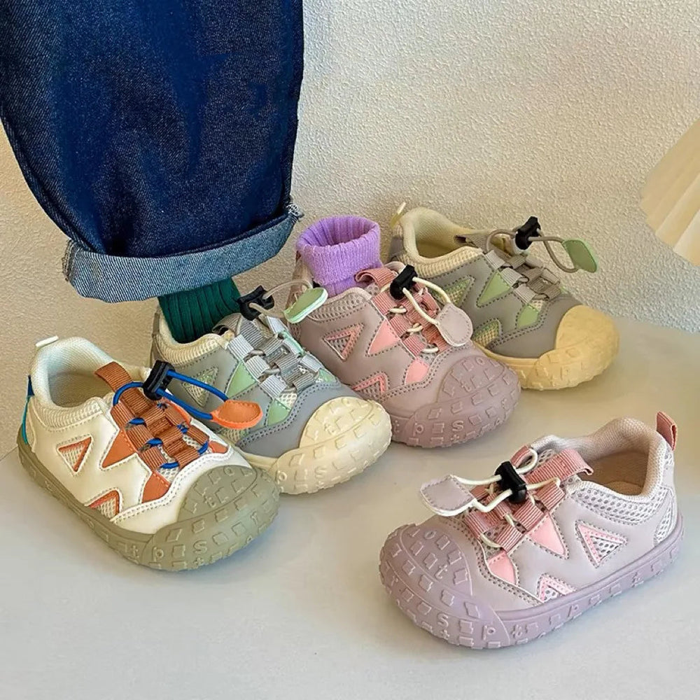 Kids' sneakers in three colorways, showing mesh panels and adjustable cord closures