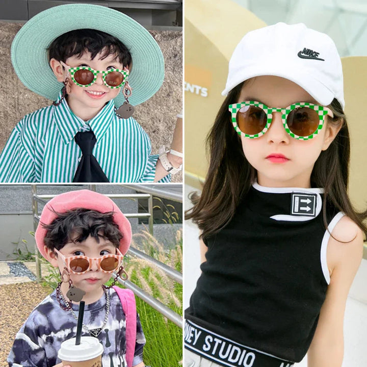 Children wearing green checkered and pale pink round sunglasses.
