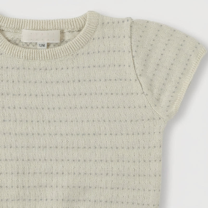 Close-up of the round ribbed neckline and openwork knit on a short-sleeve top