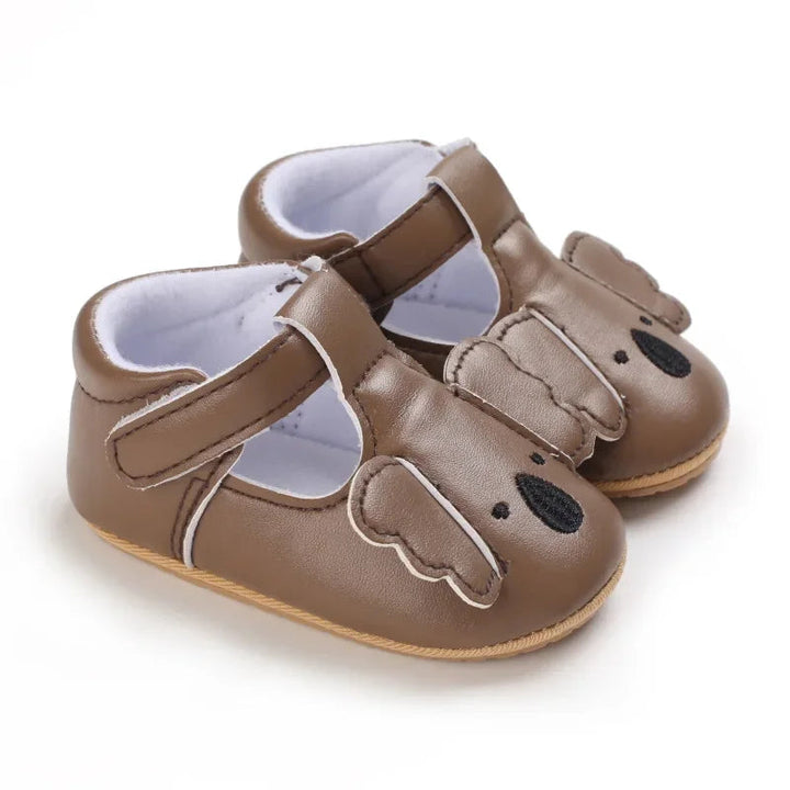Taupe koala baby shoes showing side openings and strap closures