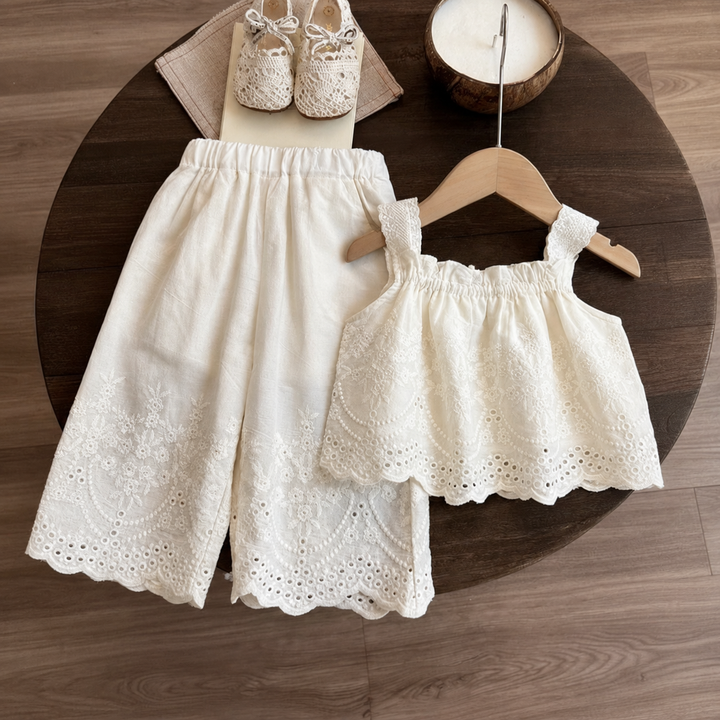 White two-piece outfit with a lace-strap top and elastic-waist wide-leg pants