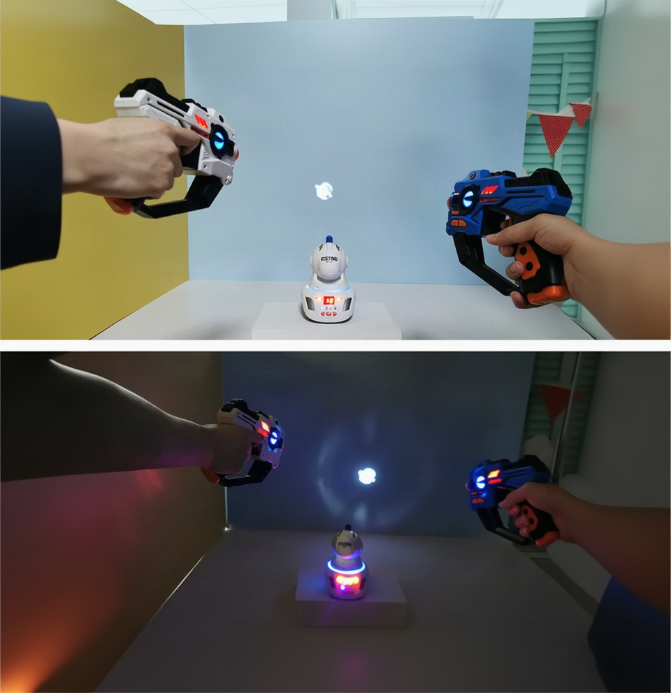 Two views of laser tag blasters aimed toward wall projections in brighter and darker room lighting.
