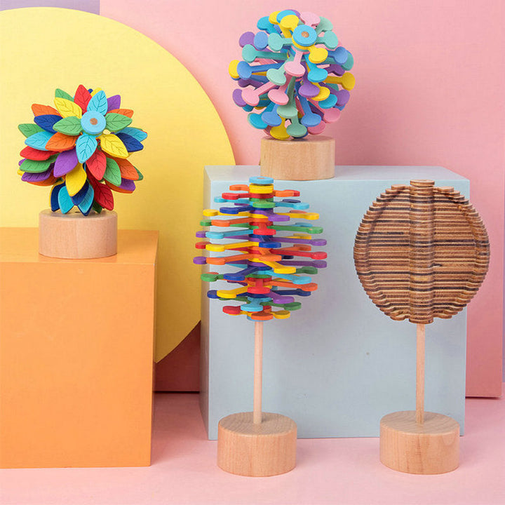 Four layered wooden lollipop toys, including colorful and natural wood designs, on display