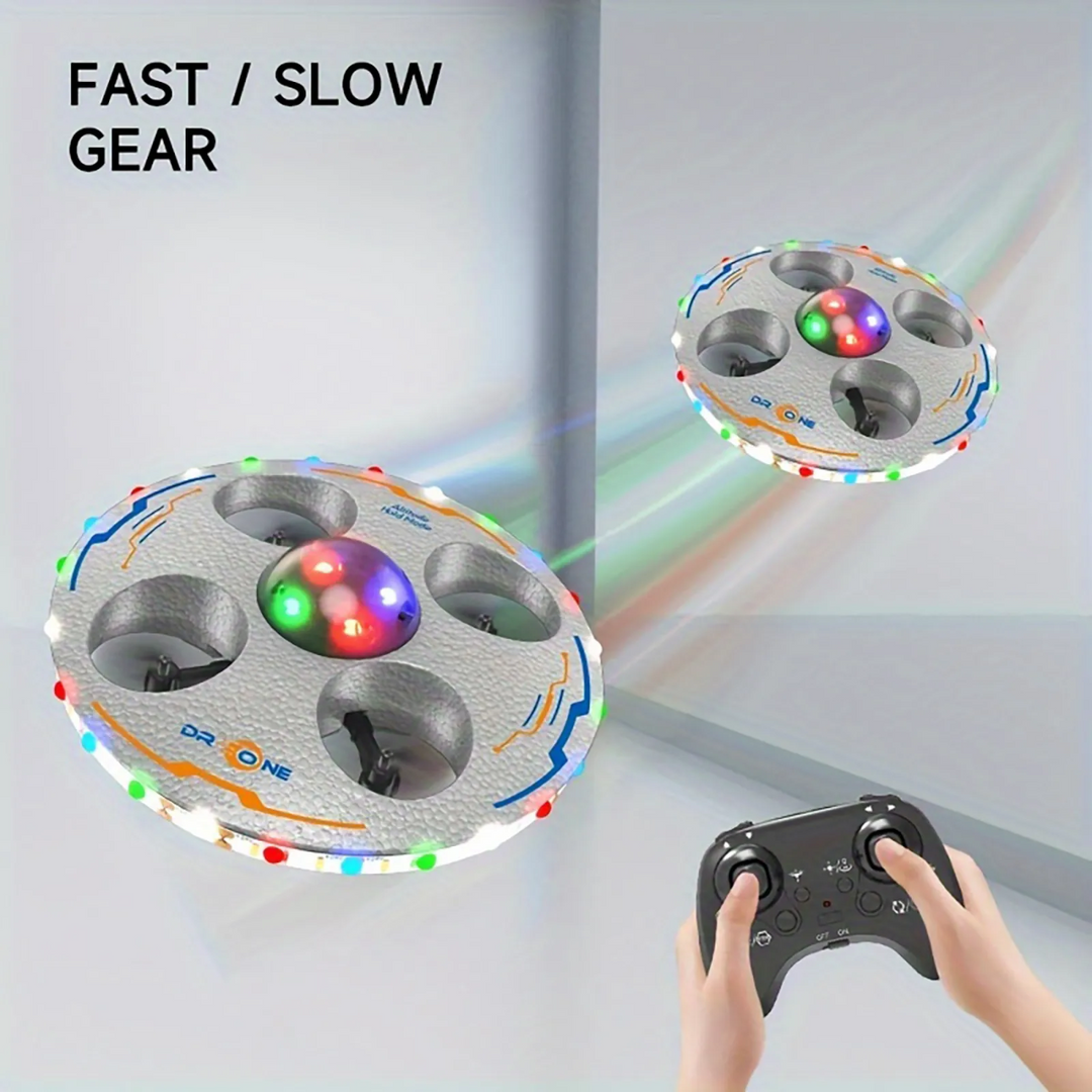 Silver LED UFO drone showing fast and slow flight settings with a handheld remote